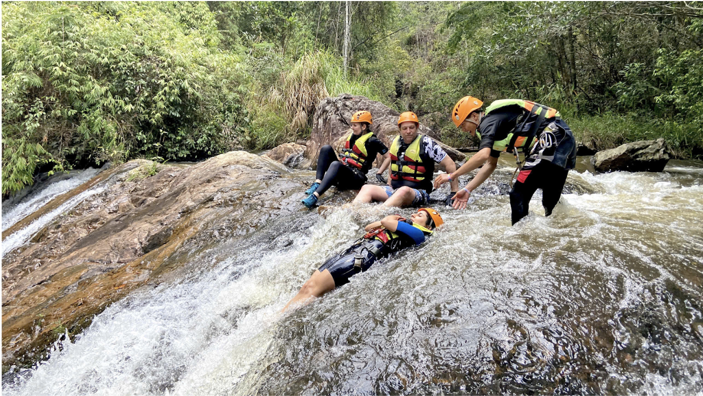 The tour guide is guiding tourists to slide